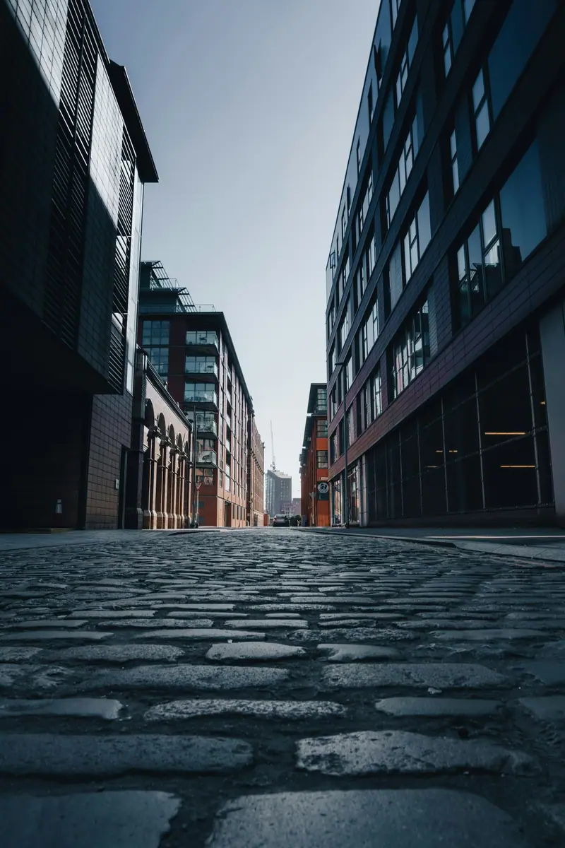 Cobbled street between brick buildings in Manchester city centre