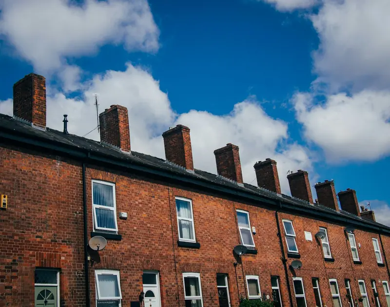 Row of red brick terraced homes in South Manchester